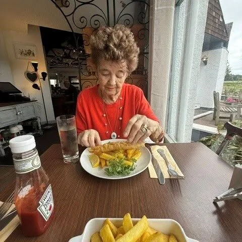 Pam eating fish and chips during lunch at the Passage House Inn